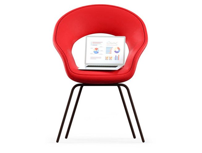 "Laptop on fabric chair at home – relaxed setup for browsing or light work"